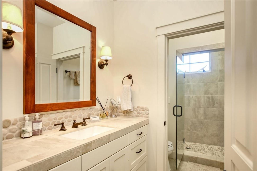 404 Huntington Road Cambria, CA 93428 - Photo 49 of 72 a bathroom with a shower sink and mirror