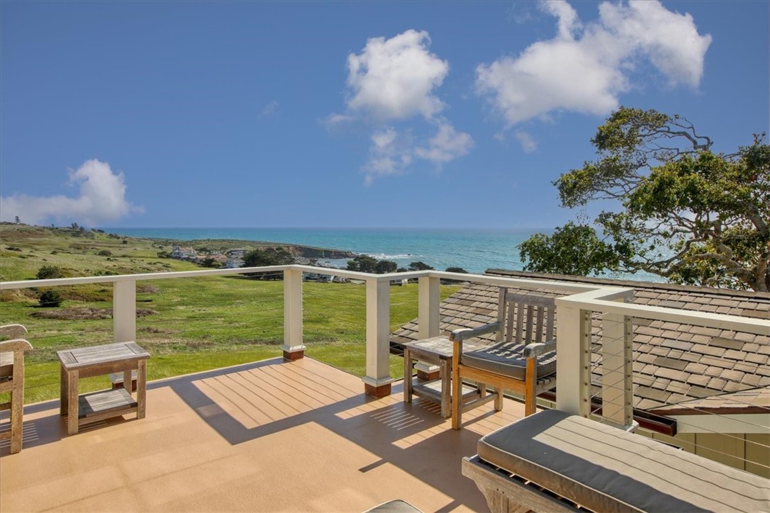 404 Huntington Road Cambria, CA 93428 - Photo 51 of 72 a view of a balcony with wooden floor and iron fence