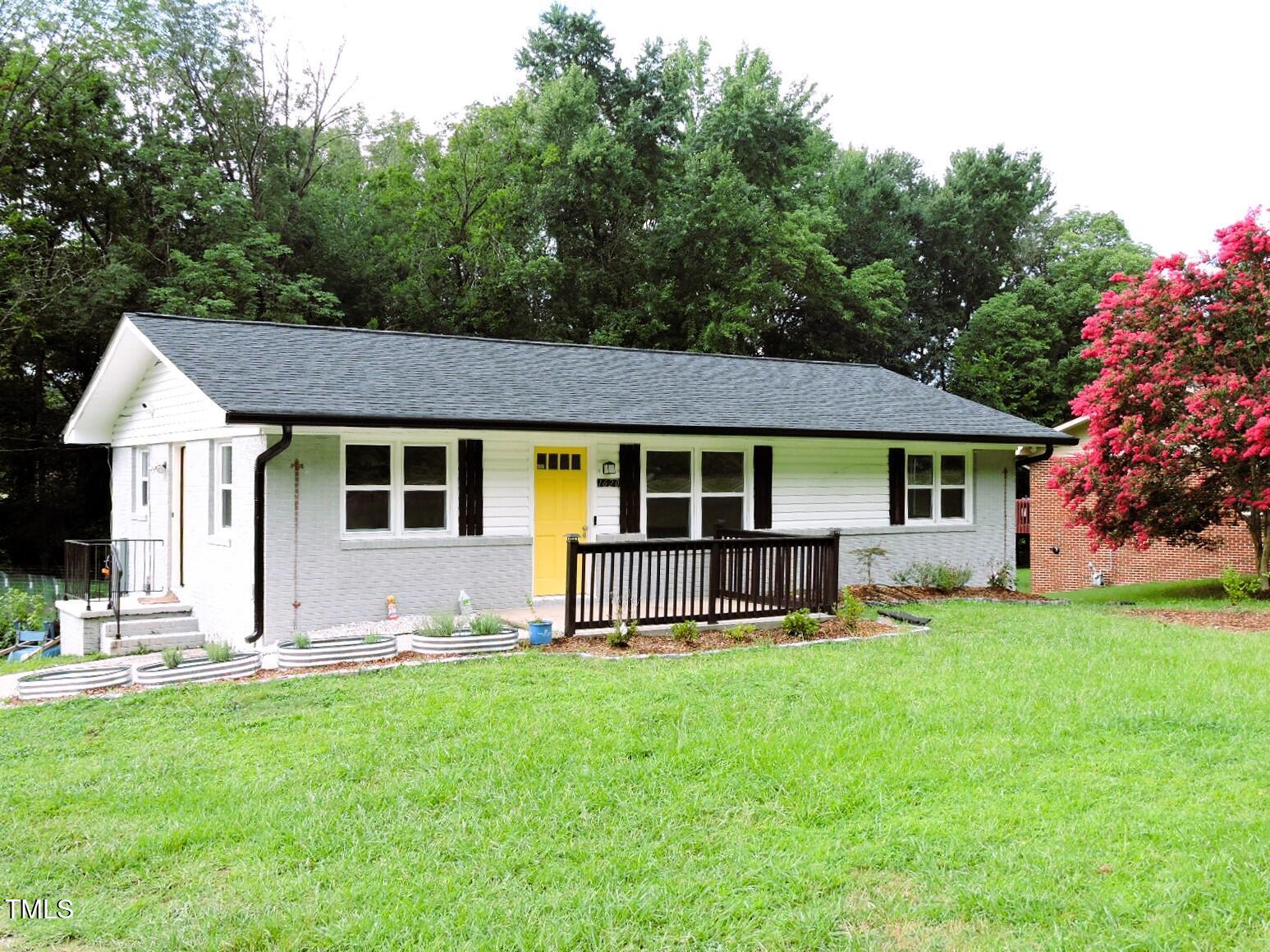 a front view of a house with a yard and sitting area