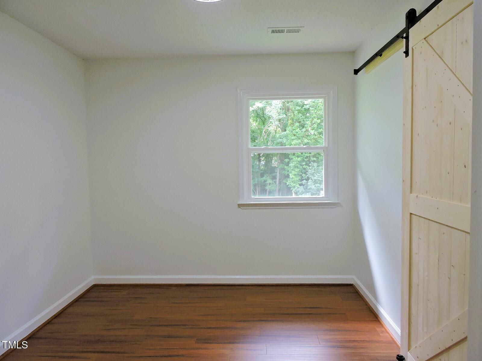 1620 Riddle Road Durham, NC 27713 - Photo 11 of 28 a view of a room with wooden floor and window
