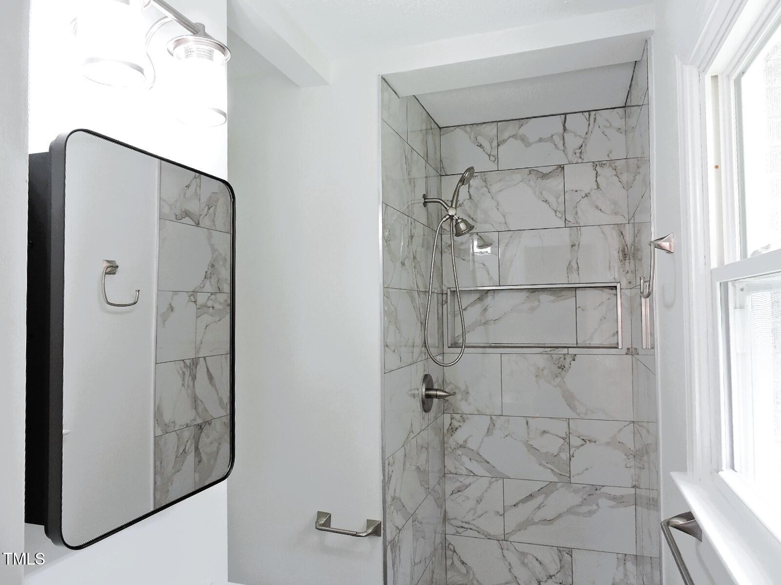 1620 Riddle Road Durham, NC 27713 - Photo 15 of 28 a bathroom with a glass shower door