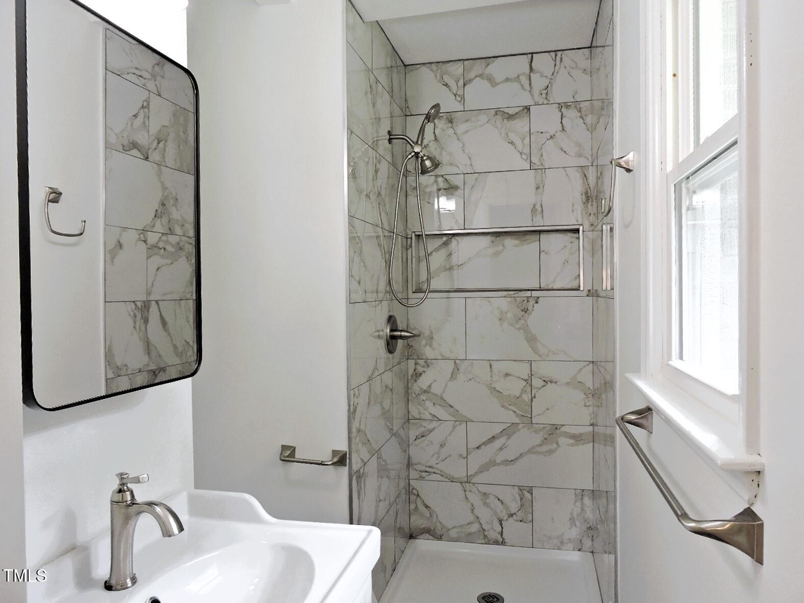 1620 Riddle Road Durham, NC 27713 - Photo 17 of 28 a bathroom with a shower and a sink
