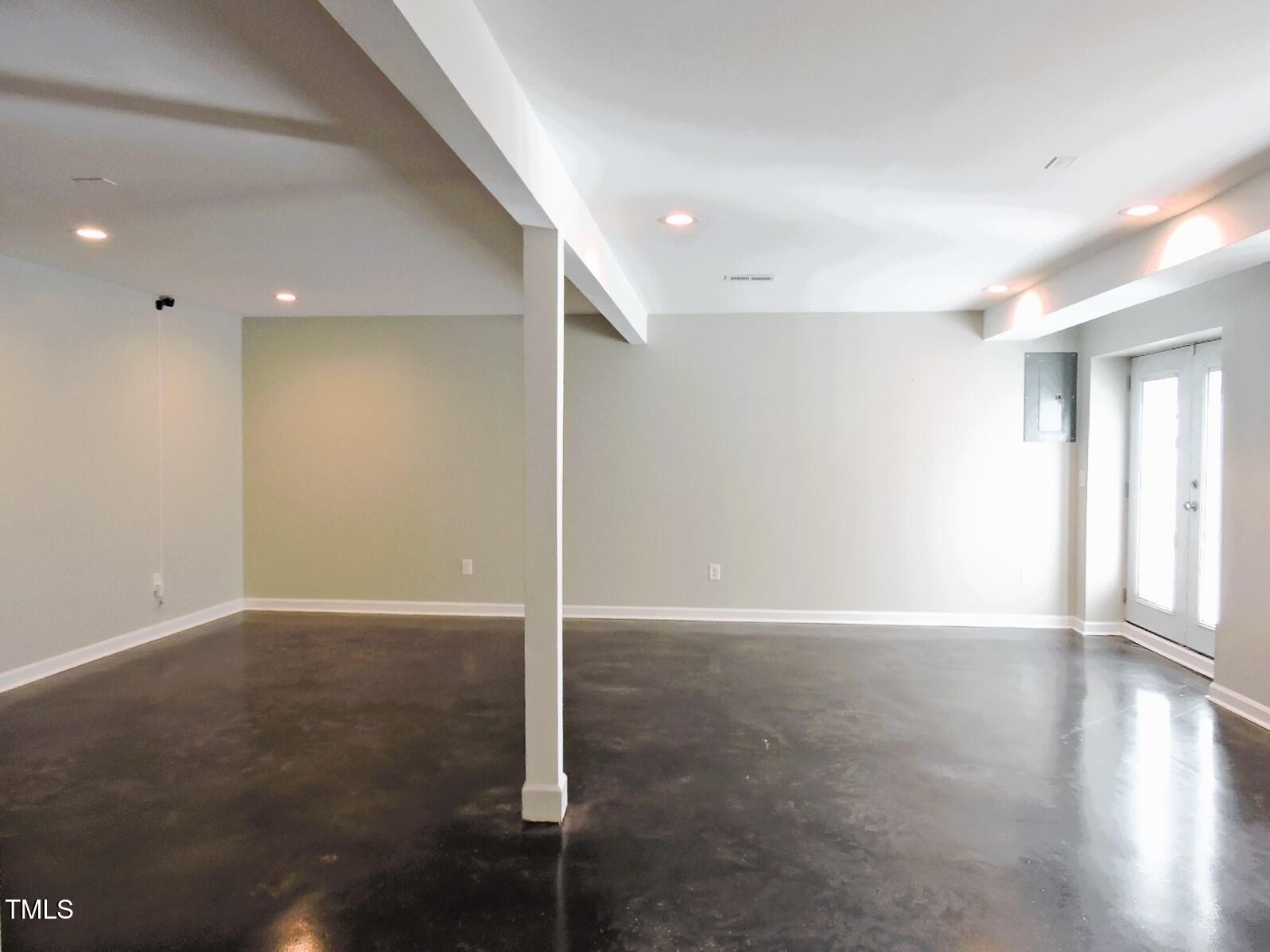 1620 Riddle Road Durham, NC 27713 - Photo 21 of 28 an empty room with wooden floor and windows with curtains