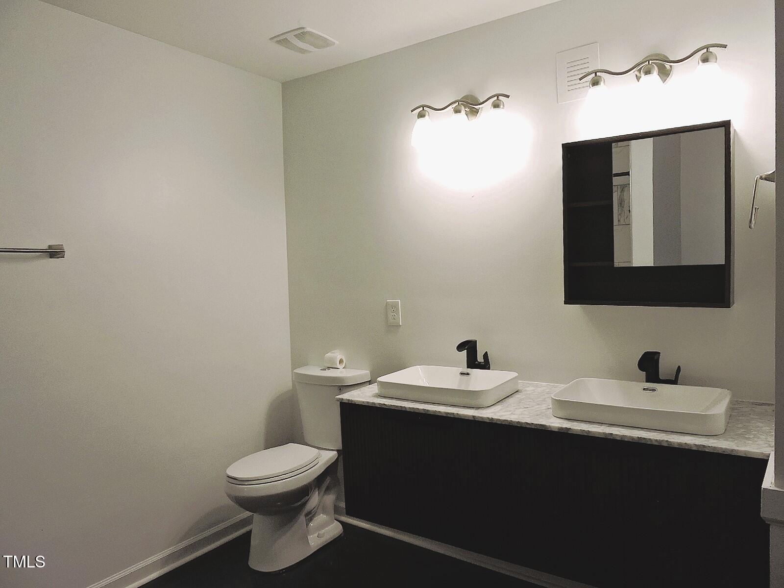 1620 Riddle Road Durham, NC 27713 - Photo 26 of 28 a bathroom with a sink and a toilet