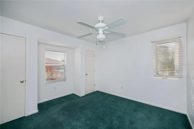 a view of house with swimming pool and porch