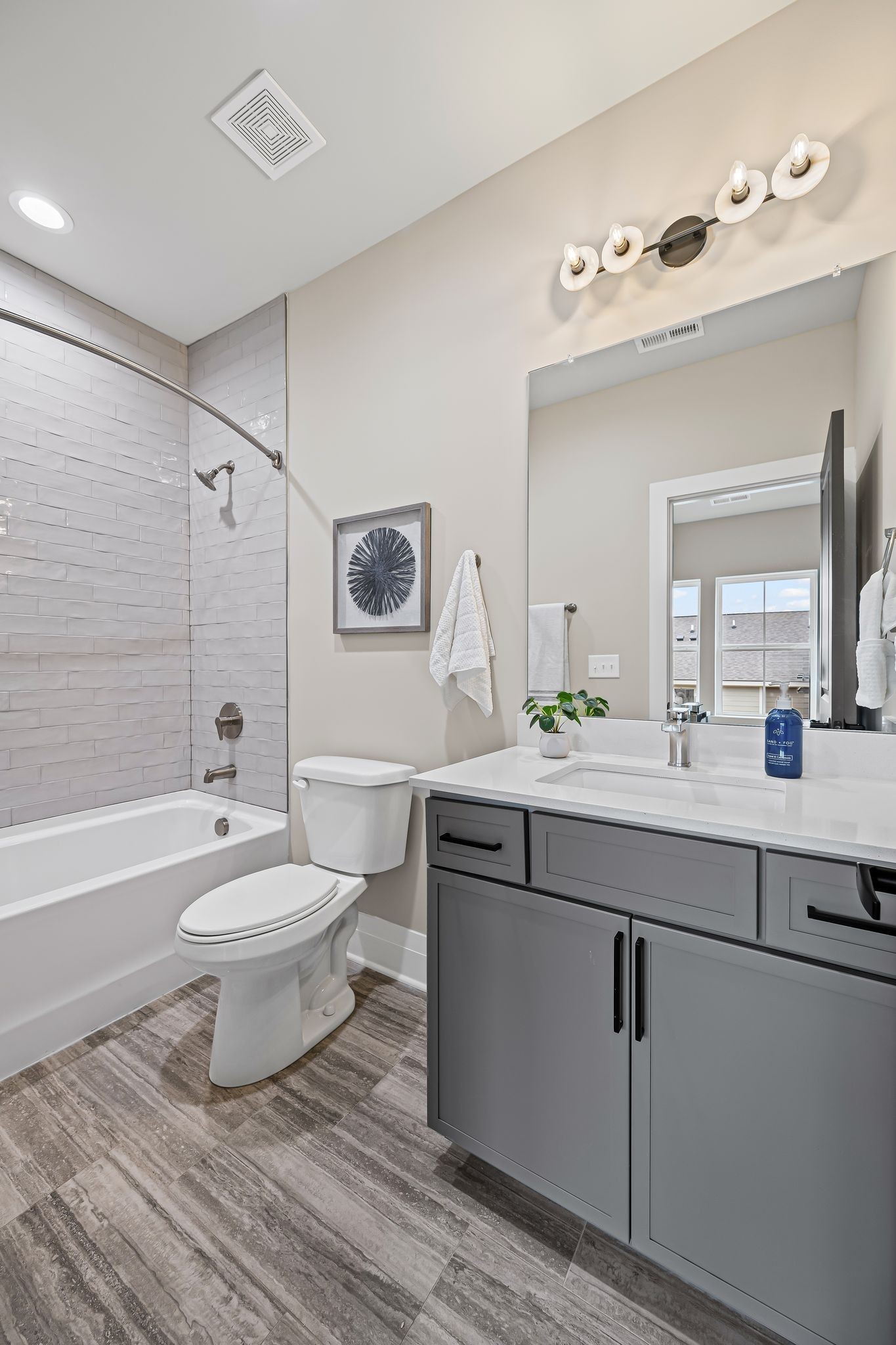 1036 Noble Loop, Unit 34 Nashville, TN 37211 - Photo 25 of 34 a bathroom with a double vanity sink toilet mirror and bathtub