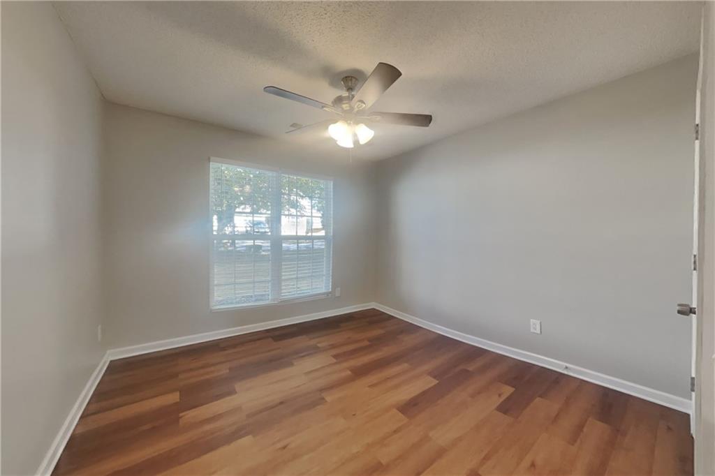 257 Ashland Park Court Southeast Lawrenceville, GA 30045 - Photo 12 of 21 a view of an empty room with wooden floor and a window