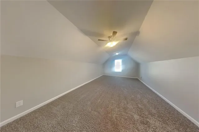 a front view of a house with a garden and yard