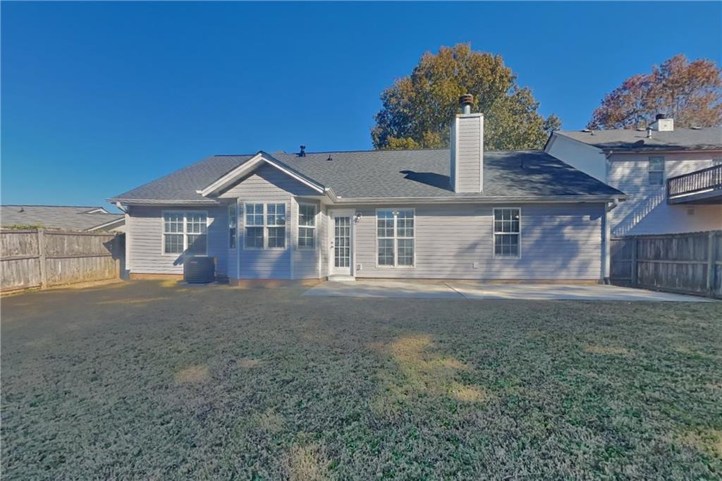 257 Ashland Park Court Southeast Lawrenceville, GA 30045 - Photo 19 of 21 a front view of a house with a garden and yard