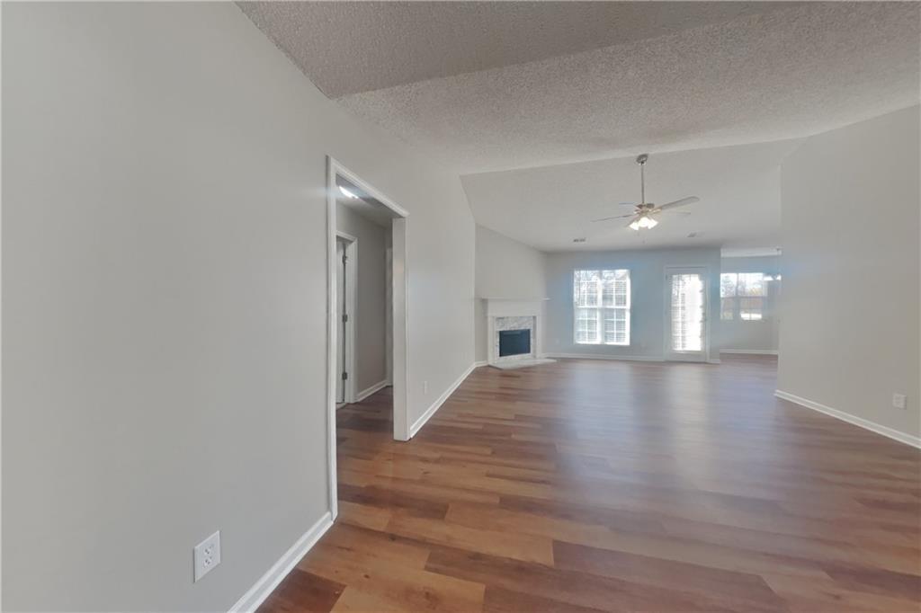 257 Ashland Park Court Southeast Lawrenceville, GA 30045 - Photo 3 of 21 a view of an empty room with window and wooden floor