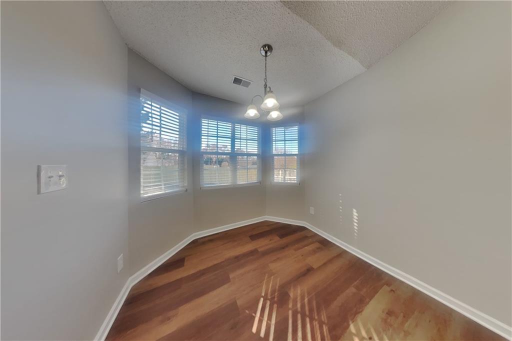 257 Ashland Park Court Southeast Lawrenceville, GA 30045 - Photo 6 of 21 a bedroom with a bed and a window