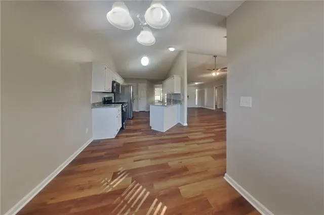 a view of a kitchen with a refrigerator and microwave