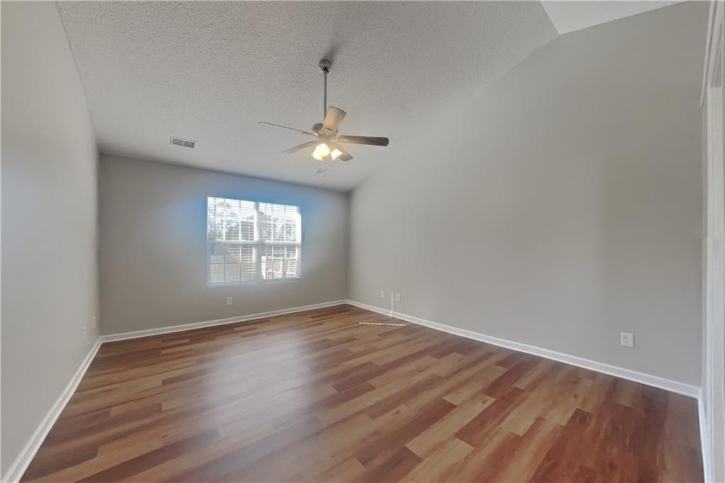 257 Ashland Park Court Southeast Lawrenceville, GA 30045 - Photo 9 of 21 wooden floor in an empty room with a window