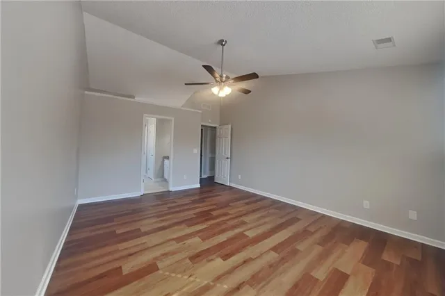 a view of an empty room with a ceiling fan