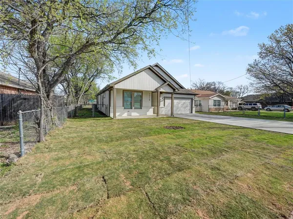 a house with huge green field in front of it