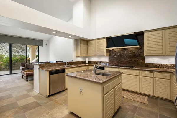a kitchen with a sink stove and cabinets