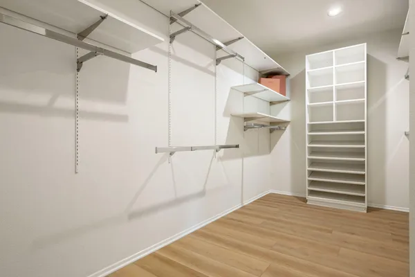 a view of walk in closet with empty racks