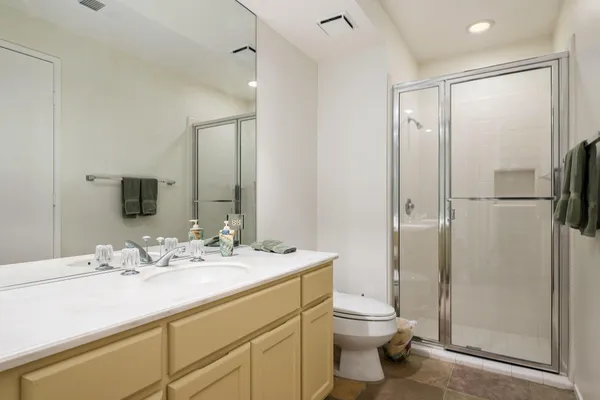 a bathroom with a double vanity sink toilet and shower