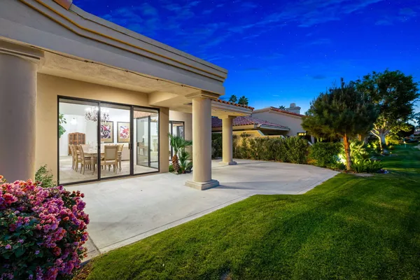 a view of a house with backyard and porch