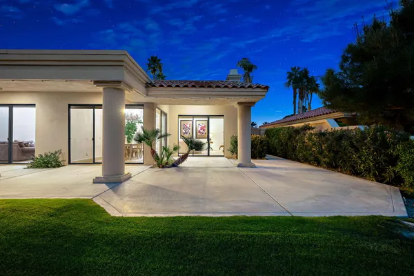 a view of a house with backyard and porch