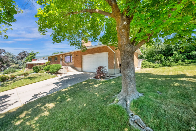 1783 South 500 East Bountiful, UT 84010 - Photo 27 of 30 Brick exterior with an attached garage and a mature shade tree