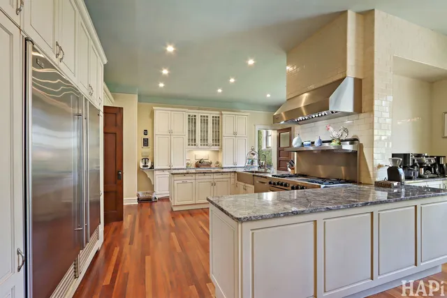 a view of a hallway with wooden floor and entryway