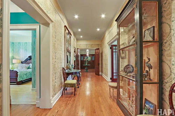 a view of a hallway with wooden floor and entryway