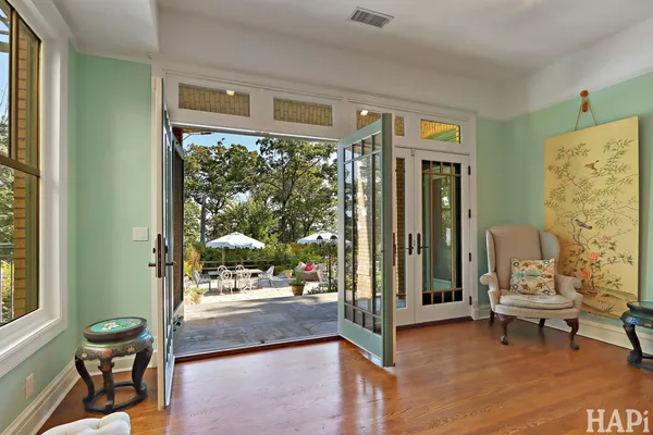 a view of a hallway with wooden floor and furniture