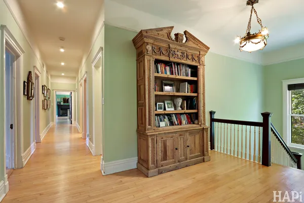 a view of a room with wooden floor windows a table and chairs
