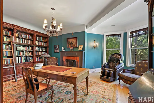 a bedroom with a bed ceiling fan and a window