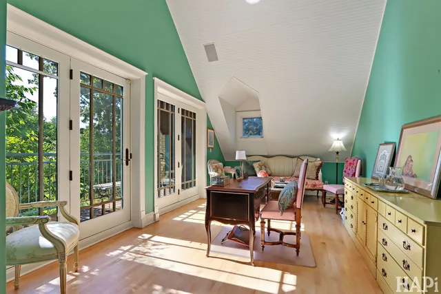 a bathroom with a tub and a view of living room