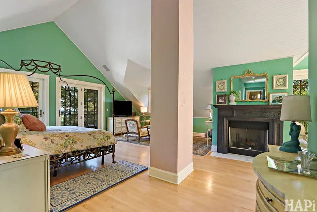 a view of a room with wooden floor windows a table and chairs