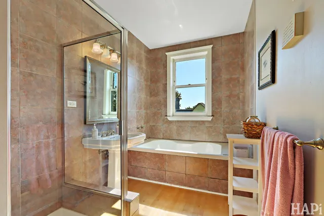 a bedroom with a bed ceiling fan and a window