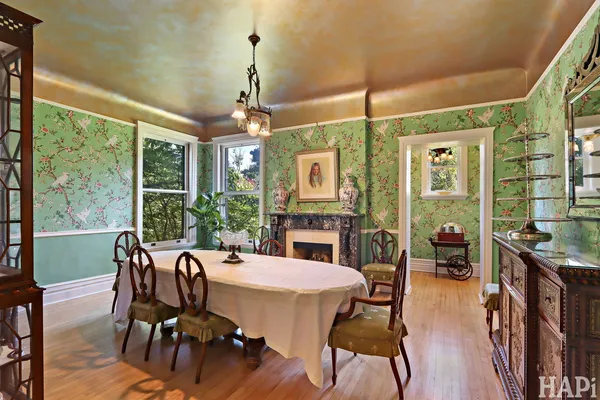 a view of a hallway with wooden floor and furniture