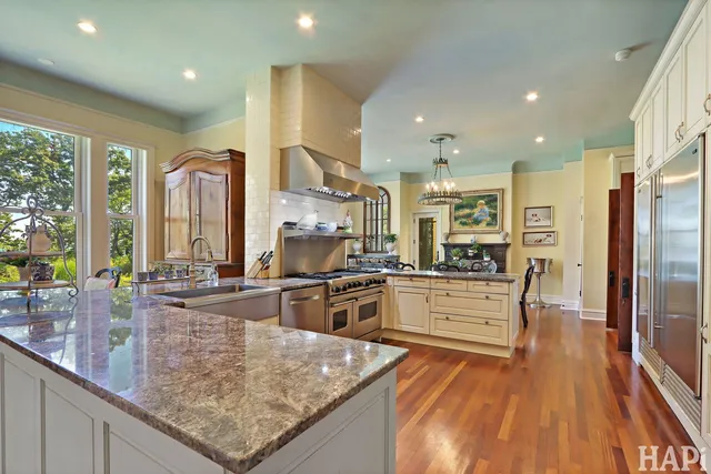 a view of a hallway with wooden floor and furniture