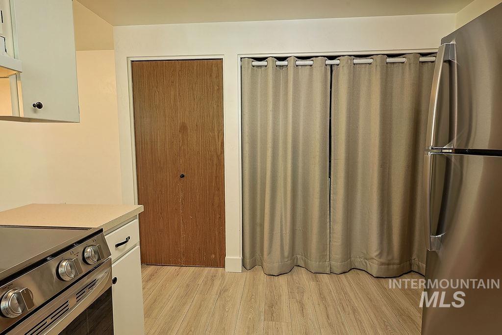 640 Morrison Street Twin Falls, ID 83301 - Photo 10 of 30 Stainless steel refrigerator and range set against wood-finish flooring