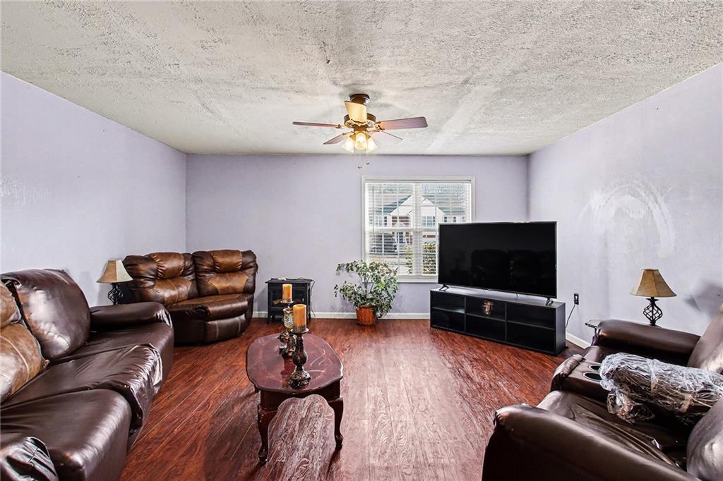 70 Feldspar Drive Jefferson, GA 30549 - Photo 17 of 22 a living room with furniture and a flat screen tv