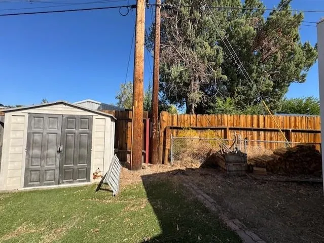 a view of a house with backyard and a fence