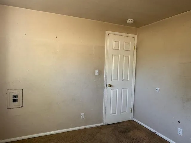 an empty room with sliding glass door