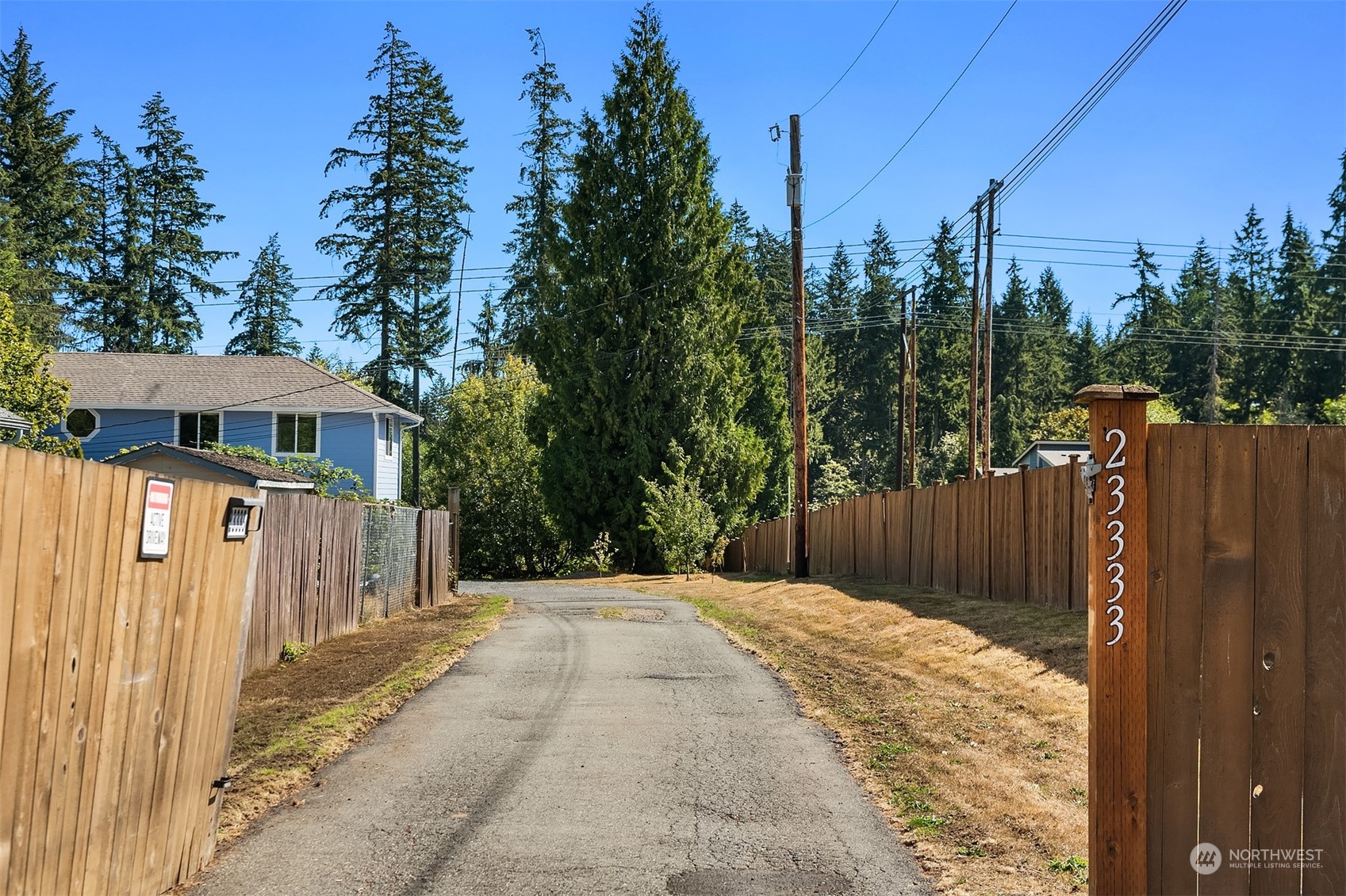 23333 45th Avenue Southeast Bothell, WA 98021 - Photo 4 of 36 a view of backyard with small cabin and wooden fence