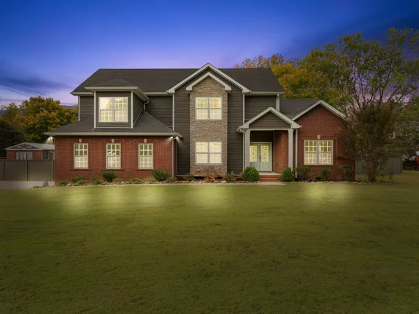 a front view of a house with a garden