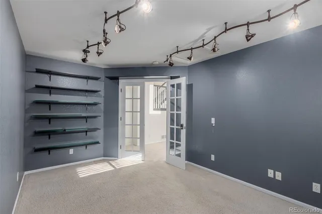 a view of a room with cabinets and a window