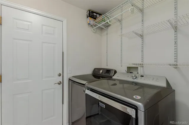 a view of a house with a big yard and large tree