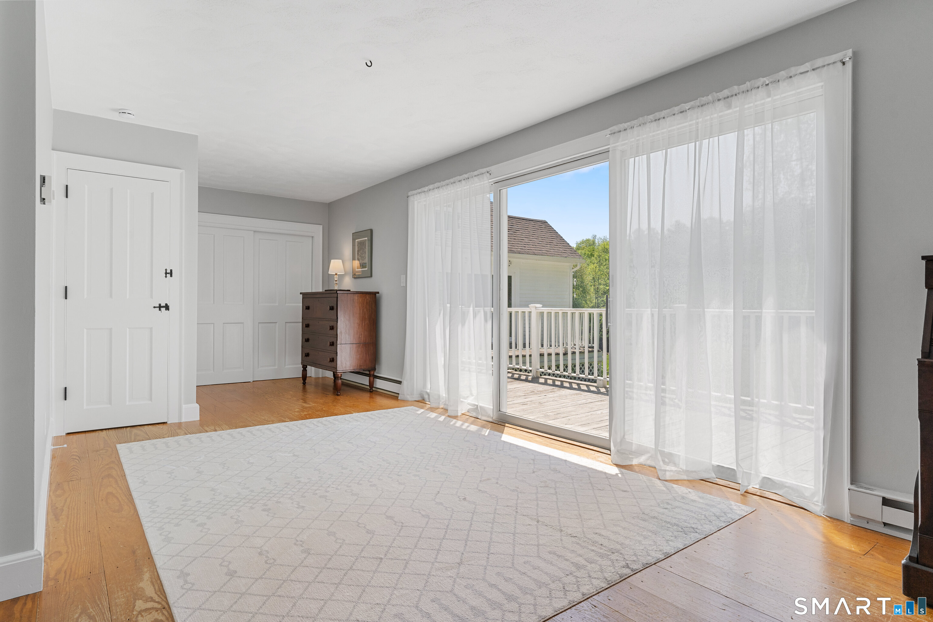 93 Upton Road Ashford, CT 06278 - Photo 23 of 40 Primary bedroom serenely gazes out upon the vast back landscape with easy access to back deck through its own sliding glass door.