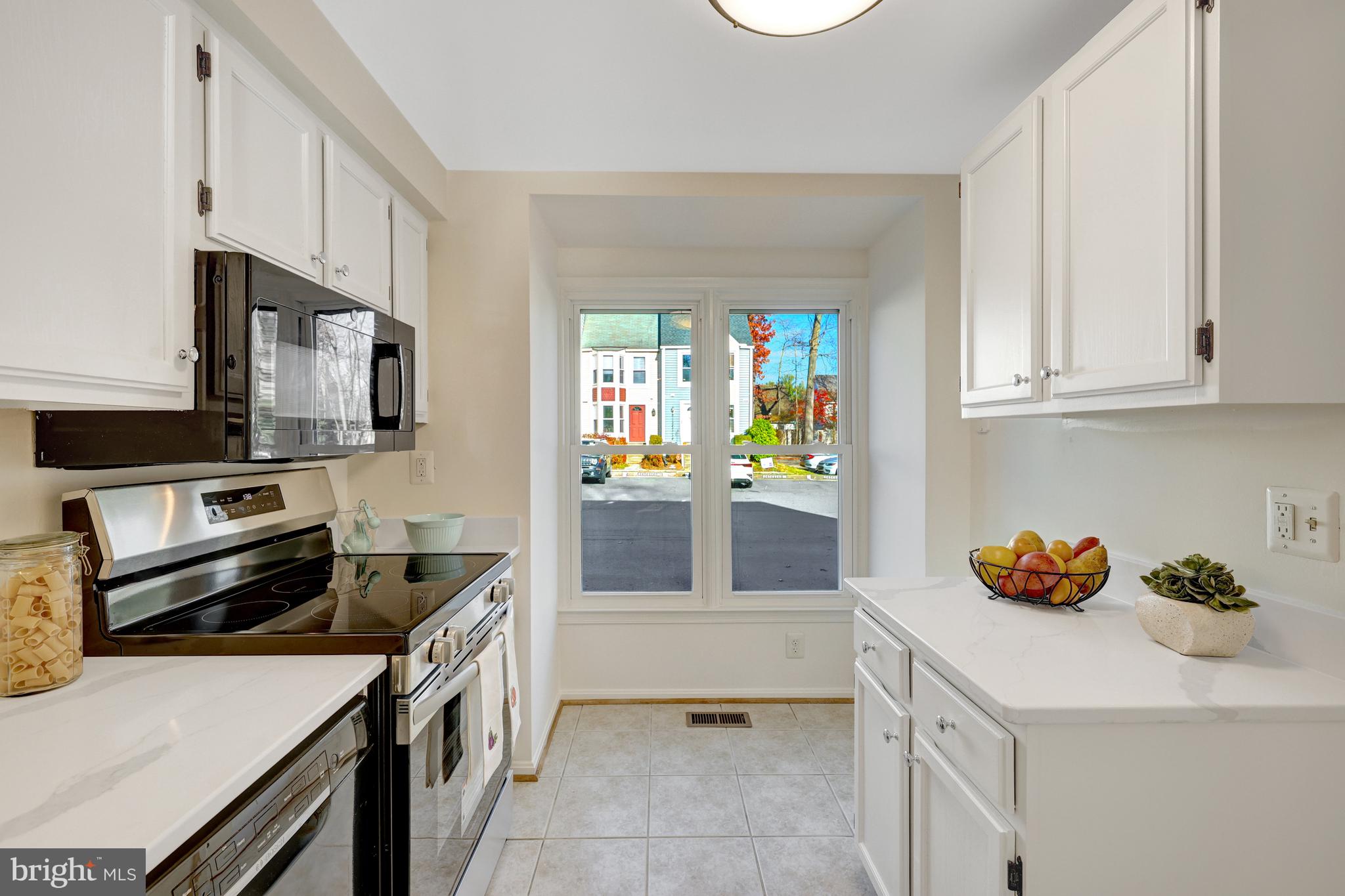 11200 Silentwood Lane Reston, VA 20191 - Photo 11 of 46 a kitchen with stainless steel appliances a stove a sink and a refrigerator