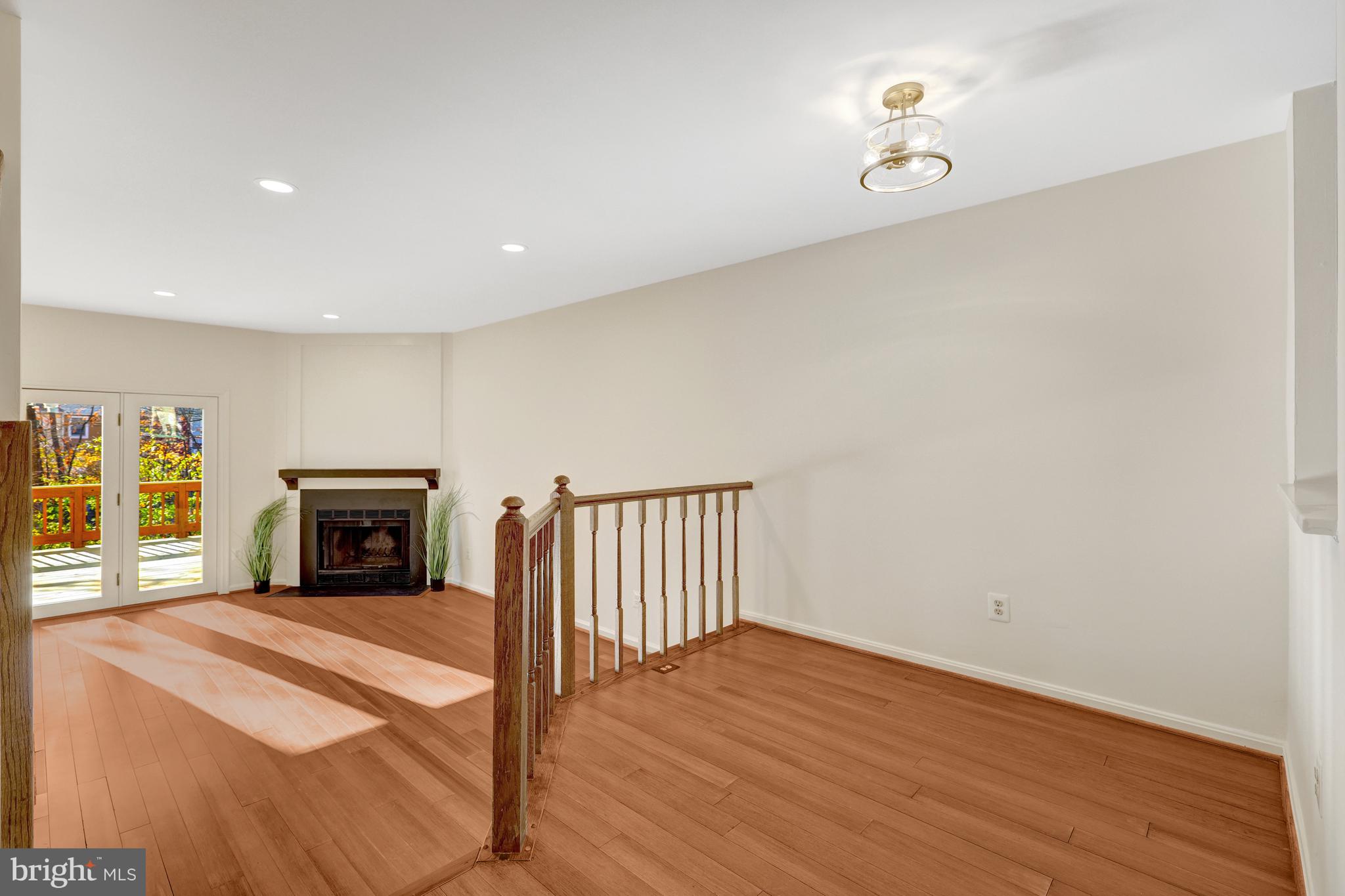 11200 Silentwood Lane Reston, VA 20191 - Photo 15 of 46 a view of a livingroom with wooden floor and fireplace