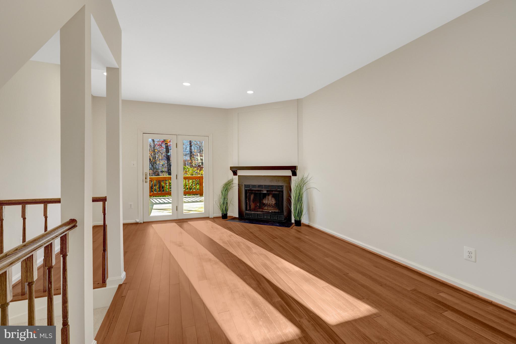 11200 Silentwood Lane Reston, VA 20191 - Photo 17 of 46 a view of an empty room with wooden floor fireplace and a window