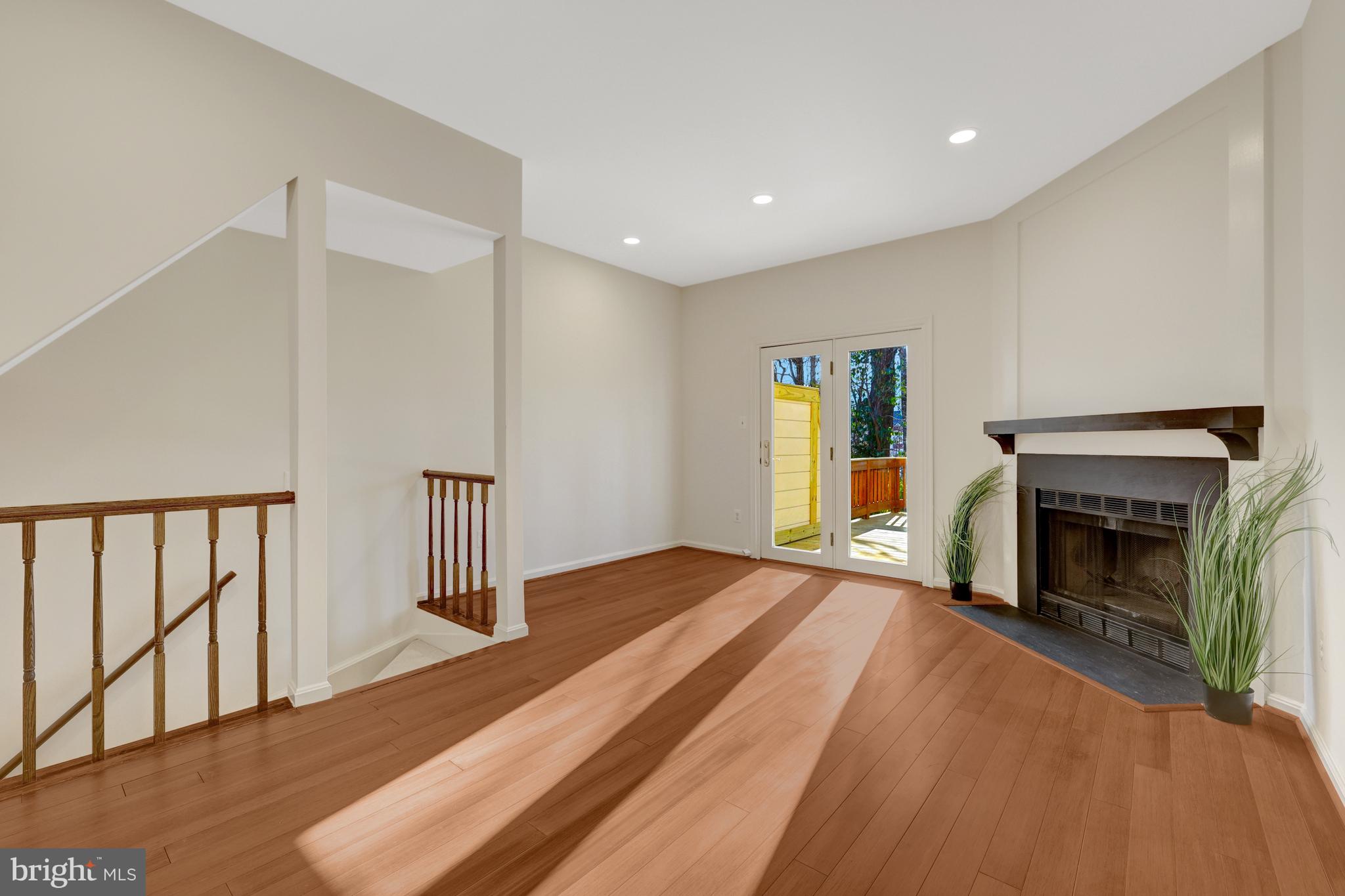 11200 Silentwood Lane Reston, VA 20191 - Photo 18 of 46 a view of an empty room with wooden floor fireplace and a window