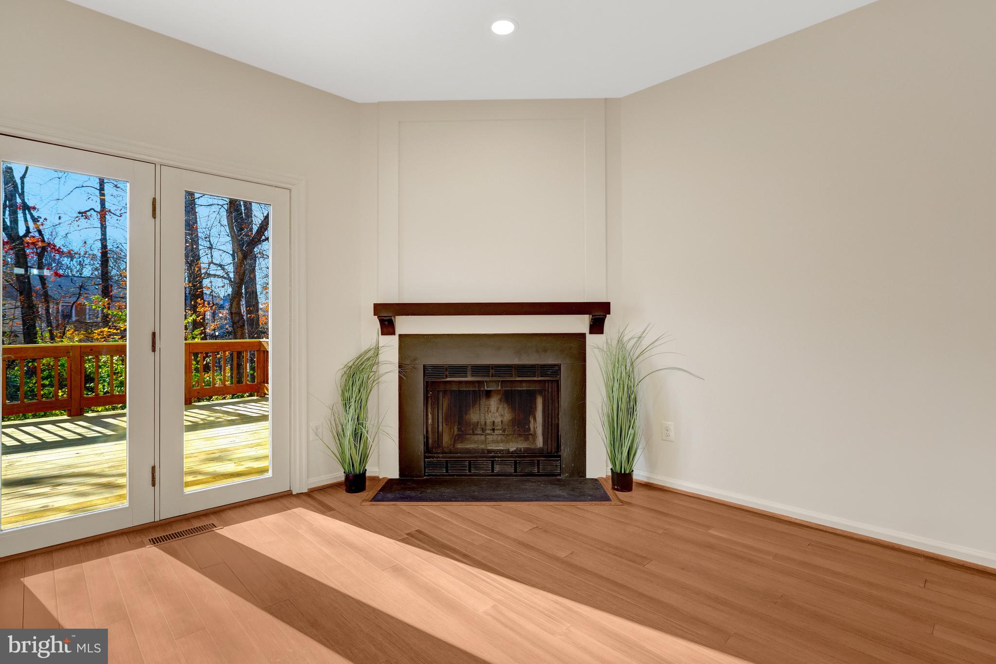 11200 Silentwood Lane Reston, VA 20191 - Photo 19 of 46 a view of an empty room with wooden floor fireplace and a window