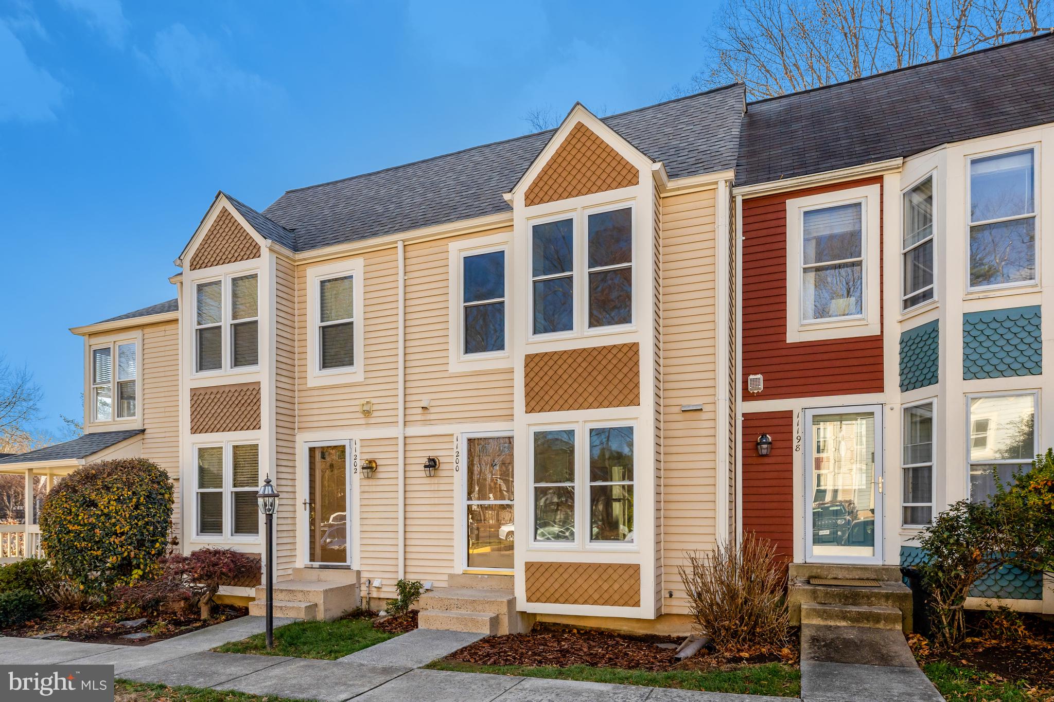 11200 Silentwood Lane Reston, VA 20191 - Photo 2 of 46 a front view of a house with a yard